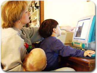 mother and children looking at computer
